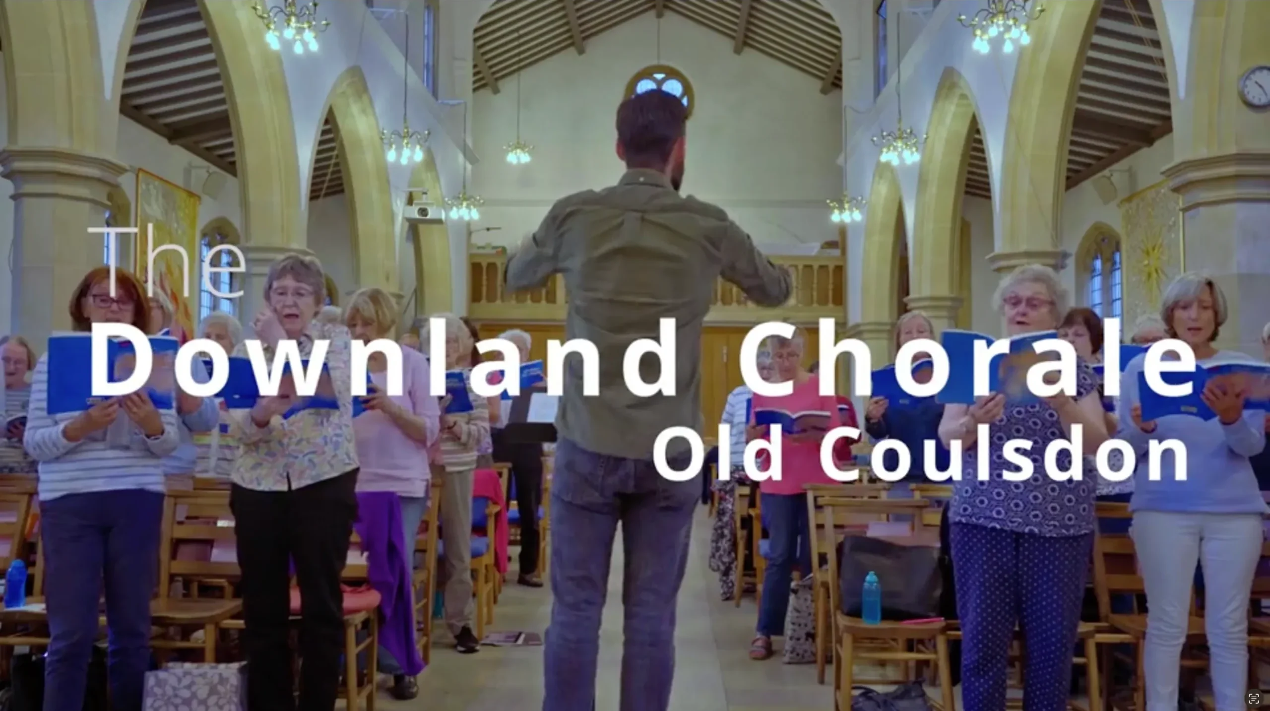 Downland Chorale Choir singing in a church during a promotional event.